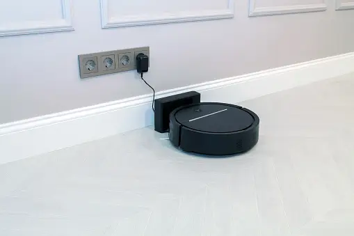 Shark robot vacuum plugged in to a charging port